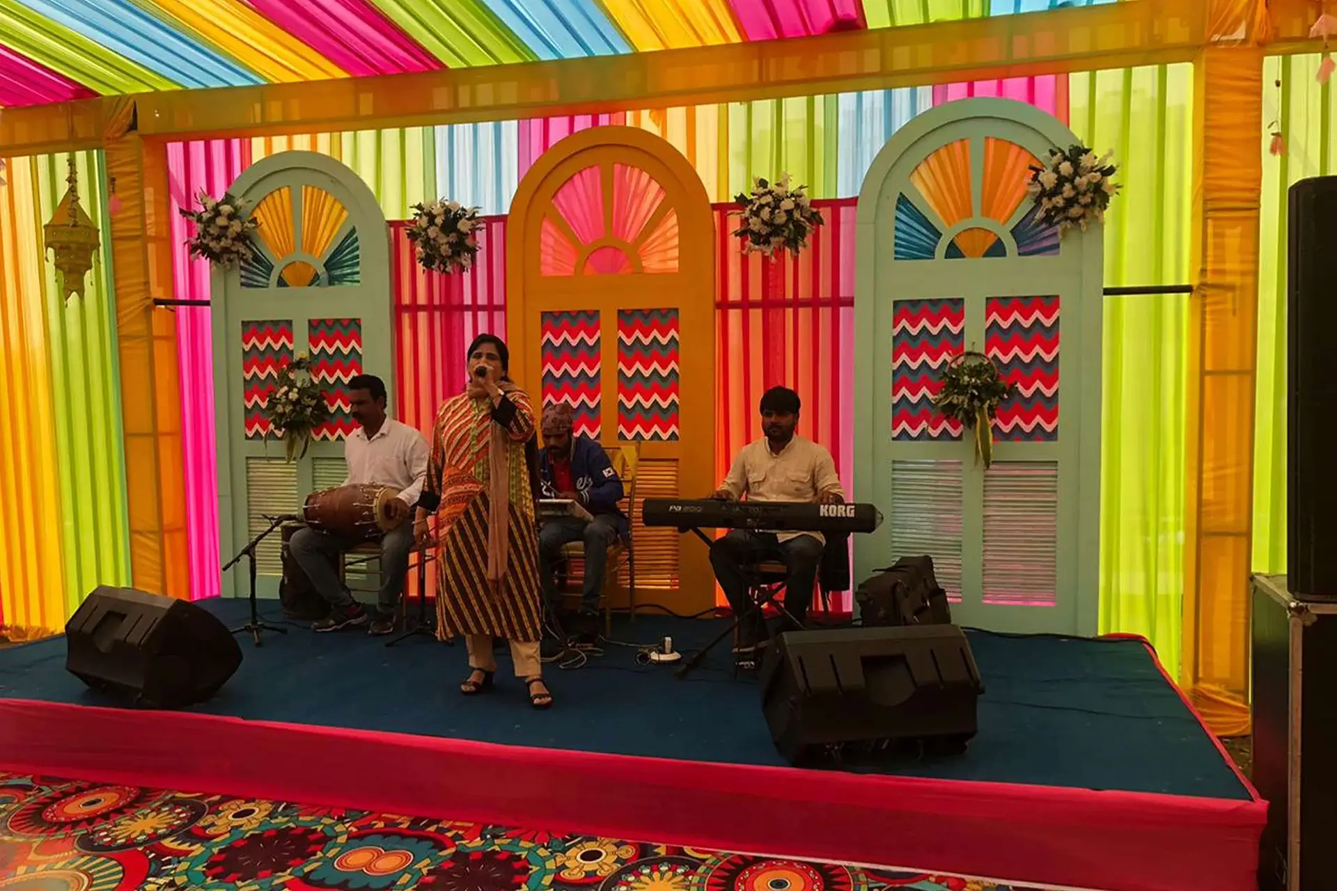 Reception stage backdrop with floral installation and warm lighting